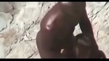 Big black dude gets his dick sucked and fucks his girlfriend doggy style on the beach caught on cam by a peeper