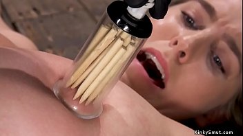 Brunette slave Cadence Lux is shackled on the wooden floor and spreaded then nipples tormented with suction cups and wooden sticks in them